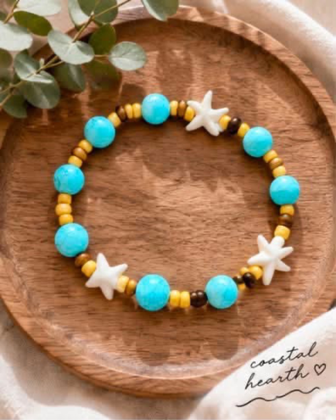 Turquoise and wood starfish bracelet on wooden tray